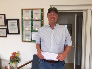 Doug Lawton receiving his $100 in Chamber Bucks.